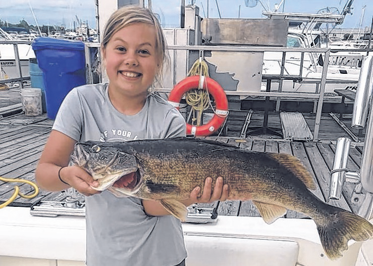 Peyton Fletcher hoists her catch which made for a win in the youth division of the 2019 Walleye Derby.